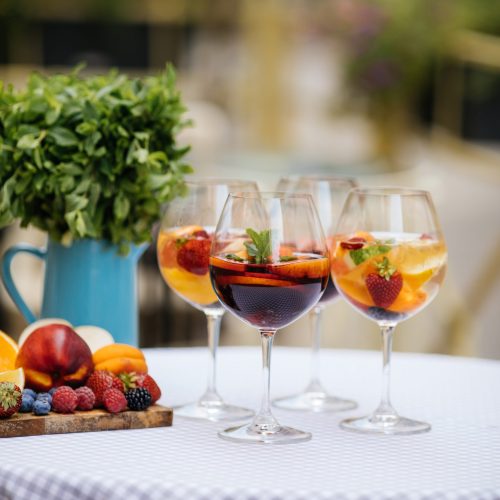 Summer drink Sangria with orange and cranberry. Selective focus. Copy space
