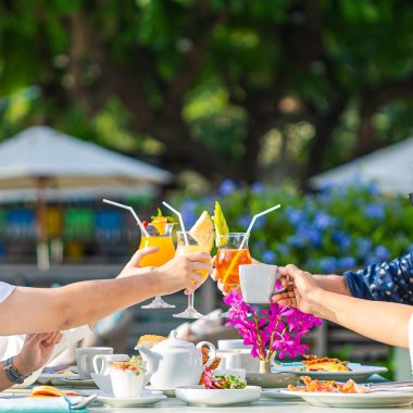 breakfast-hands-clinking-drinks-group-people-having-brunch-together-table-top-view