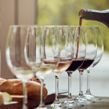 Shot of a man enjoying a cheese platter and tasting different wines.