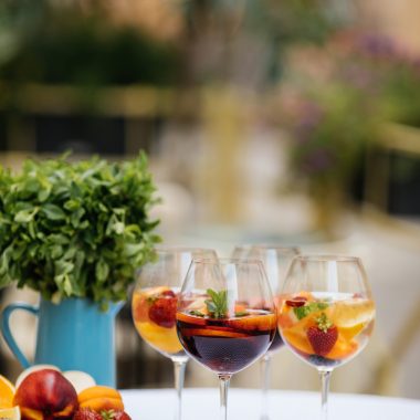 Summer drink Sangria with orange and cranberry. Selective focus. Copy space